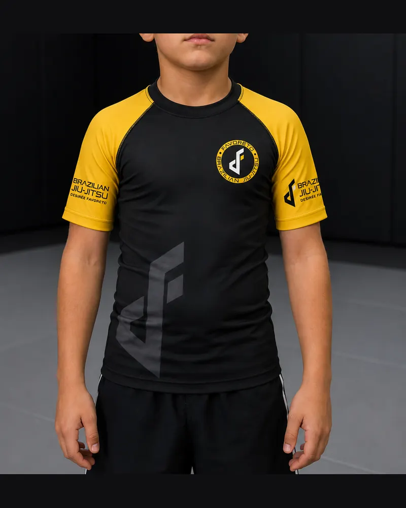 Rashguard infantil negro con mangas amarillas y escudo de Favoreto, frente